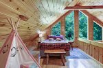 QUEEN BED AGAINST TALL A-FRAME WINDOW VIEWS